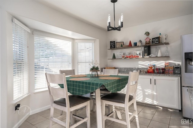 tiled dining space featuring a notable chandelier