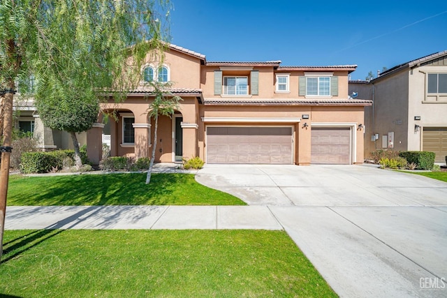 mediterranean / spanish home featuring a front yard and a garage