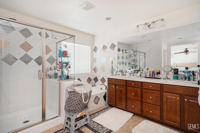 bathroom with tile patterned floors, separate shower and tub, vanity, and ceiling fan