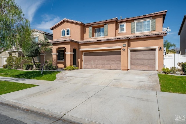 mediterranean / spanish home featuring a garage and a front yard