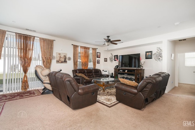 living room with light colored carpet and ceiling fan