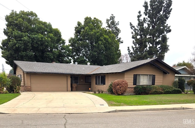 ranch-style home featuring concrete driveway, brick siding, an attached garage, and a front yard