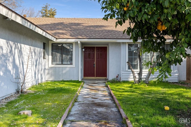 view of exterior entry featuring a yard