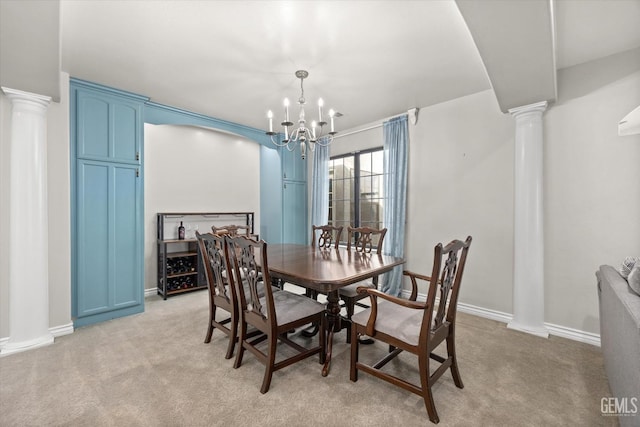 dining area featuring decorative columns, light colored carpet, and an inviting chandelier