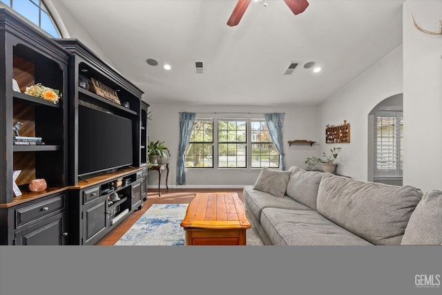 living room with vaulted ceiling, ceiling fan, and wood-type flooring