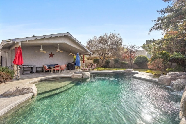 view of pool featuring a patio area and ceiling fan