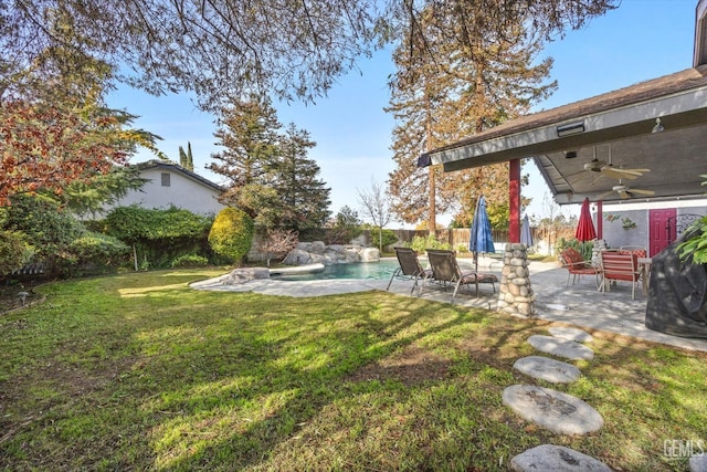 view of yard featuring ceiling fan and a patio area