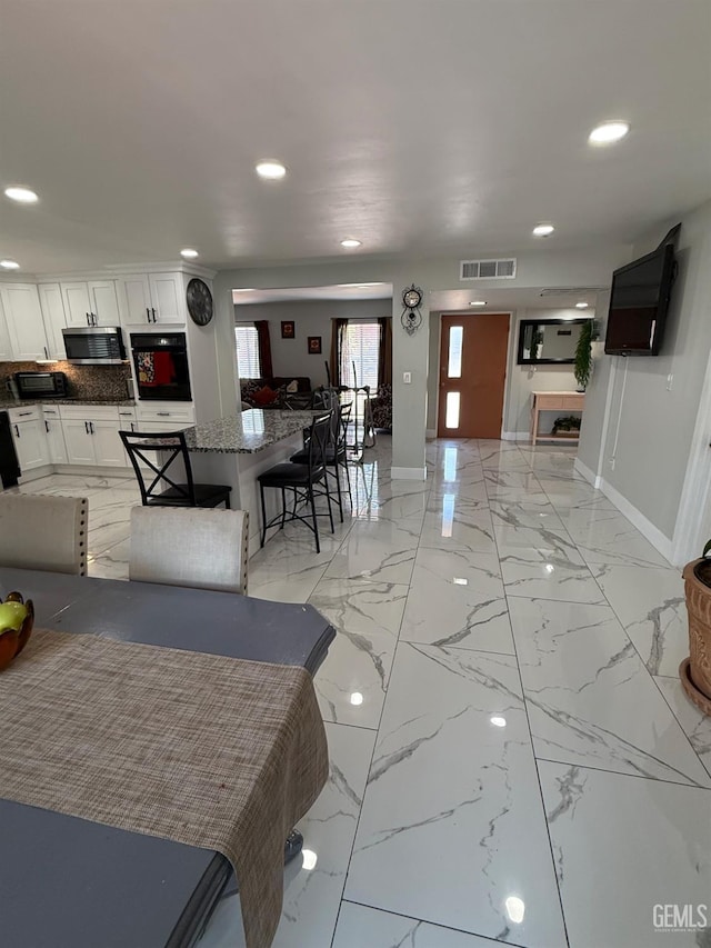 2404 Belvedere Ave, Bakersfield, CA 93304 - living area featuring recessed lighting and light marble finish flooring