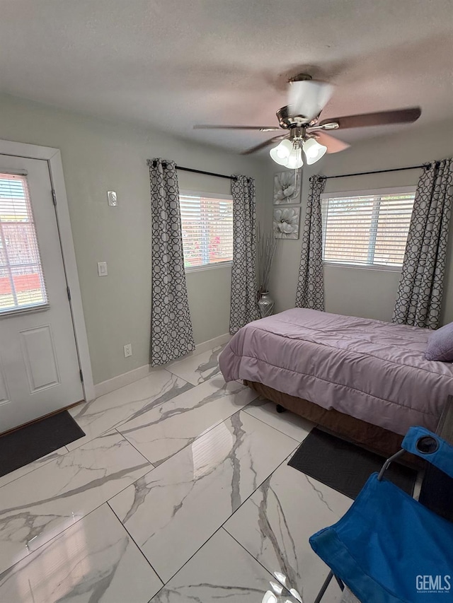 2404 Belvedere Ave, Bakersfield, CA 93304 - bedroom with multiple windows, a ceiling fan, and marble look tile flooring