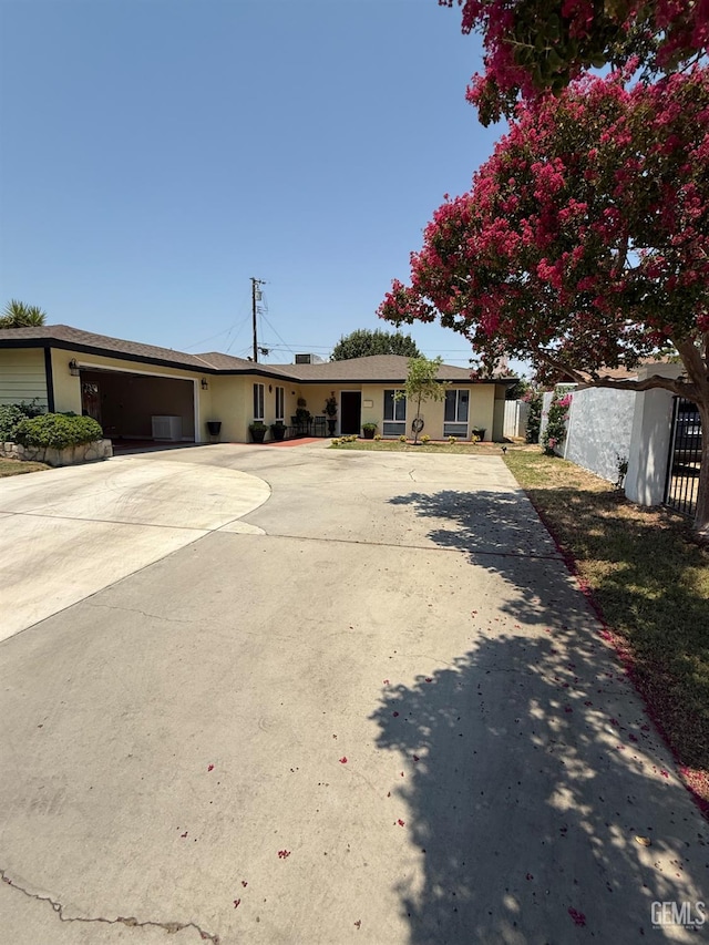 2404 Belvedere Ave, Bakersfield, CA 93304 - single story home featuring concrete driveway, an attached garage, and stucco siding