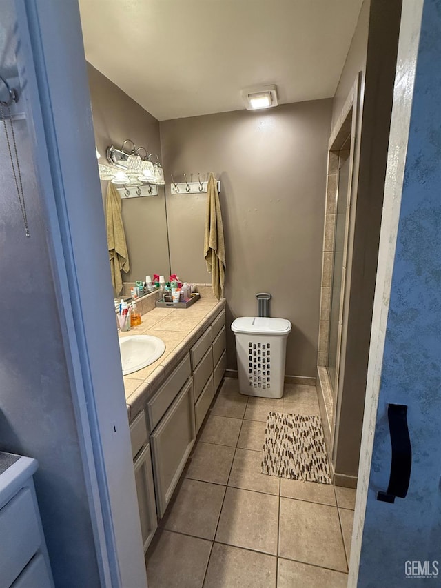 2404 Belvedere Ave, Bakersfield, CA 93304 - bathroom with tile patterned flooring, double vanity, a shower with door, and a freestanding bath