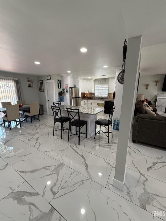 2404 Belvedere Ave, Bakersfield, CA 93304 - dining room with recessed lighting and light marble finish flooring
