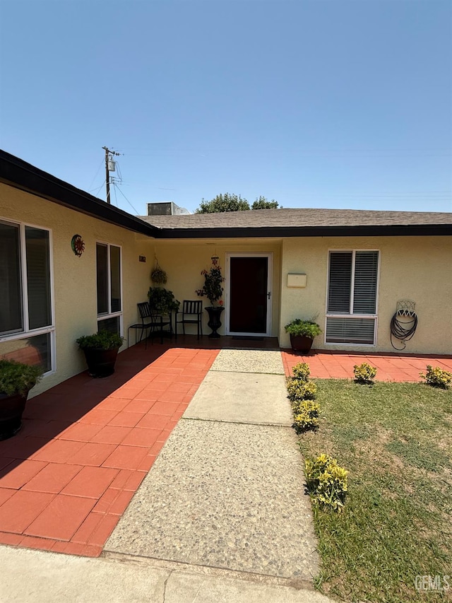 2404 Belvedere Ave, Bakersfield, CA 93304 - doorway to property featuring stucco siding and a patio area