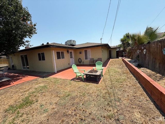 2404 Belvedere Ave, Bakersfield, CA 93304 - rear view of property featuring an outdoor fire pit, a fenced backyard, and stucco siding