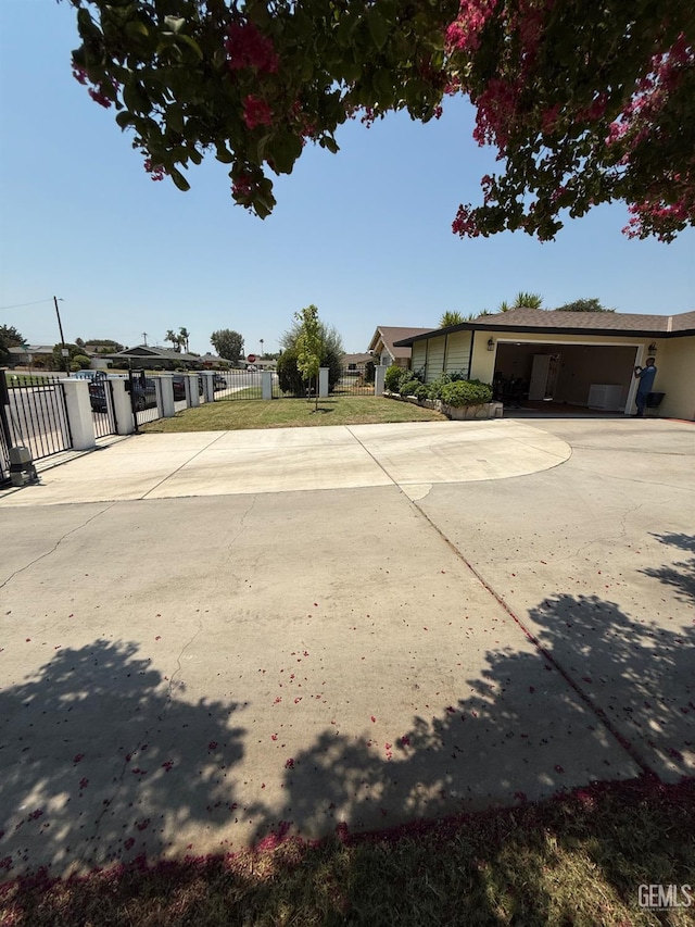 2404 Belvedere Ave, Bakersfield, CA 93304 - view of yard featuring concrete driveway and a garage