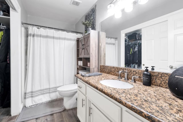 13160 Game Set Way, Bakersfield, CA 93306 - full bathroom with vanity, a walk in closet, a shower with shower curtain, and wood finished floors