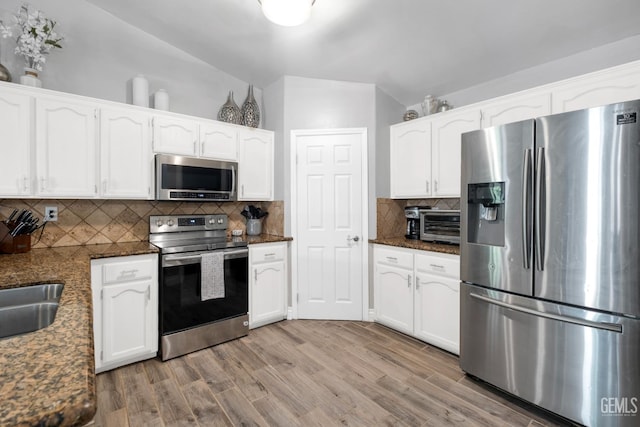 13160 Game Set Way, Bakersfield, CA 93306 - kitchen featuring stainless steel appliances, light wood-style flooring, white cabinets, lofted ceiling, and backsplash