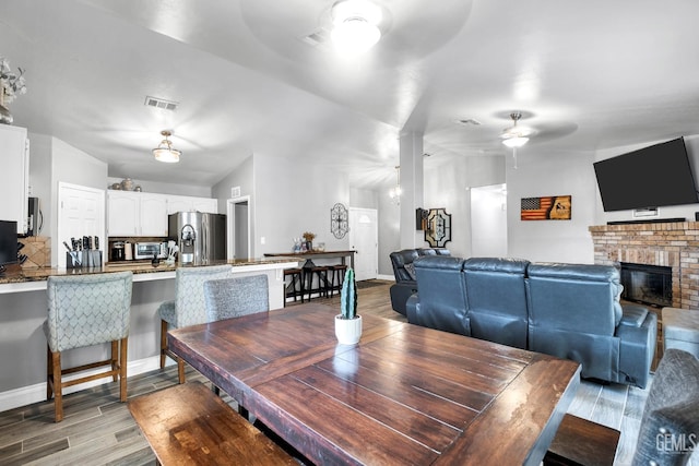 13160 Game Set Way, Bakersfield, CA 93306 - dining space with ceiling fan, light wood-type flooring, and a fireplace