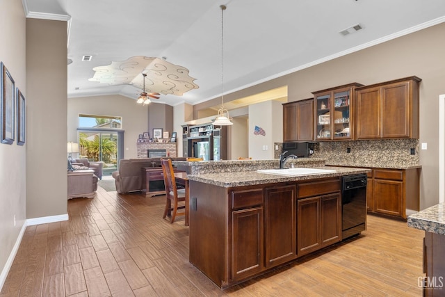 12008 Stonington St, Bakersfield, CA 93312 - kitchen with black dishwasher, a sink, a ceiling fan, light wood-type flooring, and a fireplace