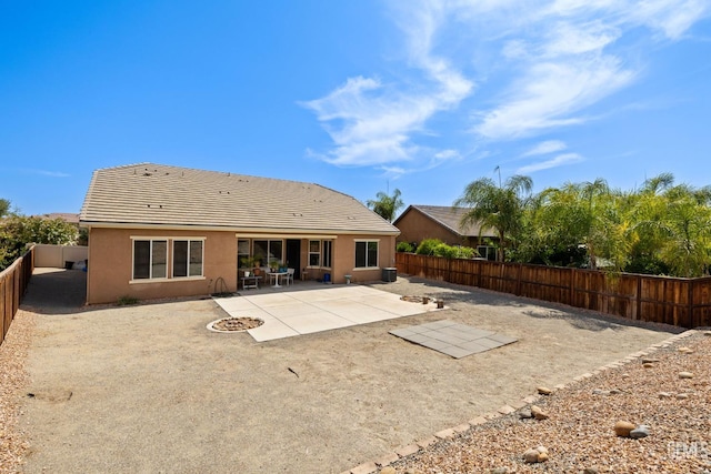 9904 Toscana Dr, Bakersfield, CA 93306 - back of property with a fenced backyard, stucco siding, a patio, and a tile roof