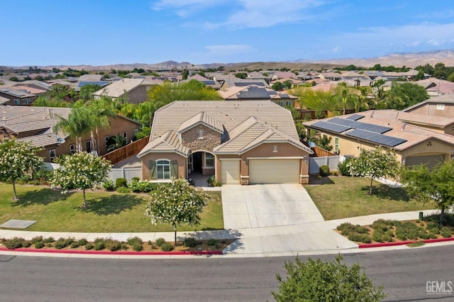 9904 Toscana Dr, Bakersfield, CA 93306 - view of front of property with a residential view, concrete driveway, an attached garage, a tiled roof, and stucco siding