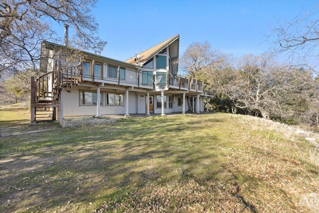 back of property with a deck and a lawn