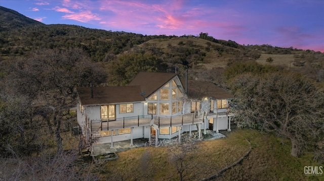 back house at dusk with a mountain view