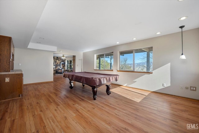 recreation room featuring ceiling fan, light hardwood / wood-style floors, and billiards