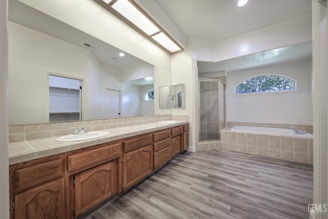 14211 Cedar Creek Ave, Bakersfield, CA 93314 - full bath with a shower stall, healthy amount of natural light, double vanity, wood finished floors, and recessed lighting