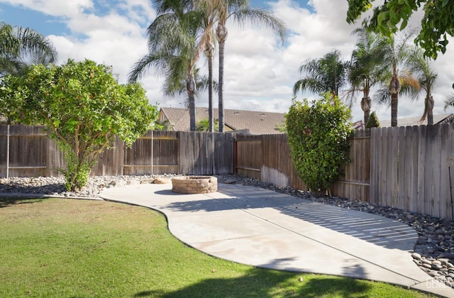 14211 Cedar Creek Ave, Bakersfield, CA 93314 - fenced backyard featuring an outdoor fire pit and a patio area