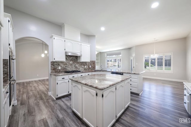 14211 Cedar Creek Ave, Bakersfield, CA 93314 - kitchen with a peninsula, backsplash, white cabinetry, dark wood-style floors, and a kitchen island