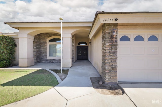 14211 Cedar Creek Ave, Bakersfield, CA 93314 - doorway to property with stone siding, an attached garage, and stucco siding