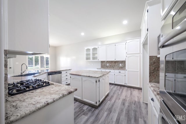 14211 Cedar Creek Ave, Bakersfield, CA 93314 - kitchen featuring appliances with stainless steel finishes, wood finished floors, backsplash, white cabinets, and recessed lighting