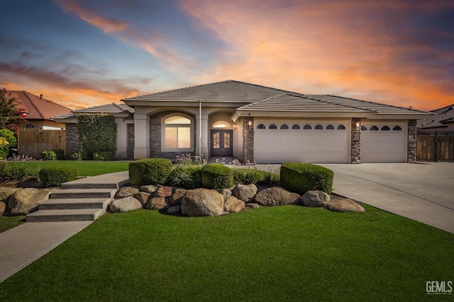 14211 Cedar Creek Ave, Bakersfield, CA 93314 - view of front of house featuring an attached garage, driveway, stone siding, a tile roof, and stucco siding