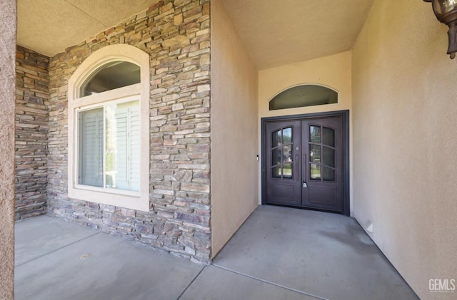 14211 Cedar Creek Ave, Bakersfield, CA 93314 - entrance to property featuring stone siding, french doors, and stucco siding