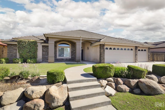 14211 Cedar Creek Ave, Bakersfield, CA 93314 - view of front facade featuring stone siding, a tile roof, an attached garage, and stucco siding