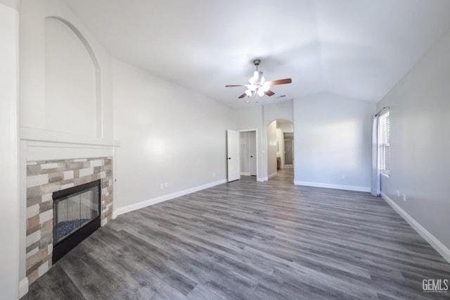 14211 Cedar Creek Ave, Bakersfield, CA 93314 - unfurnished living room with arched walkways, ceiling fan, a glass covered fireplace, lofted ceiling, and wood finished floors