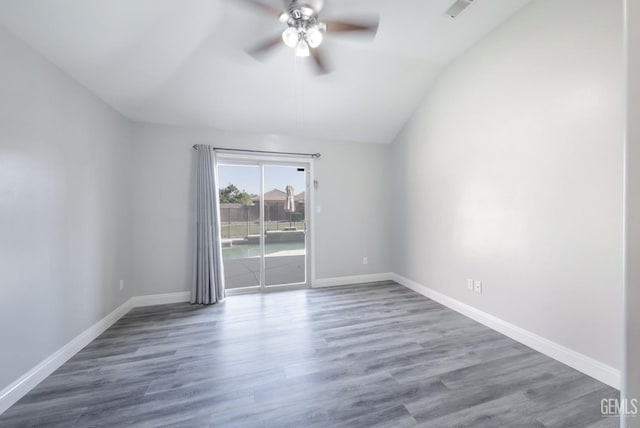 14211 Cedar Creek Ave, Bakersfield, CA 93314 - spare room featuring lofted ceiling, a ceiling fan, and wood finished floors