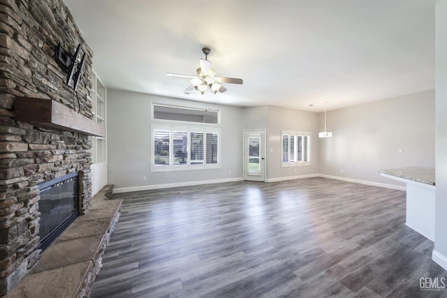 14211 Cedar Creek Ave, Bakersfield, CA 93314 - unfurnished living room featuring a fireplace, ceiling fan, and dark wood-style flooring