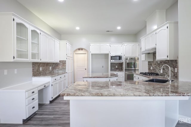 14211 Cedar Creek Ave, Bakersfield, CA 93314 - kitchen with stainless steel appliances, a peninsula, light stone countertops, recessed lighting, and backsplash
