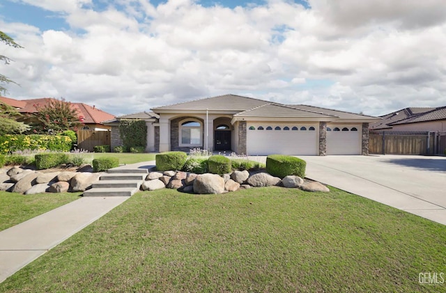 14211 Cedar Creek Ave, Bakersfield, CA 93314 - view of front facade with stone siding, a garage, concrete driveway, and a tiled roof