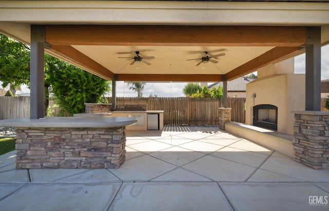 14211 Cedar Creek Ave, Bakersfield, CA 93314 - view of patio / terrace with an outdoor fireplace, a ceiling fan, and a gazebo