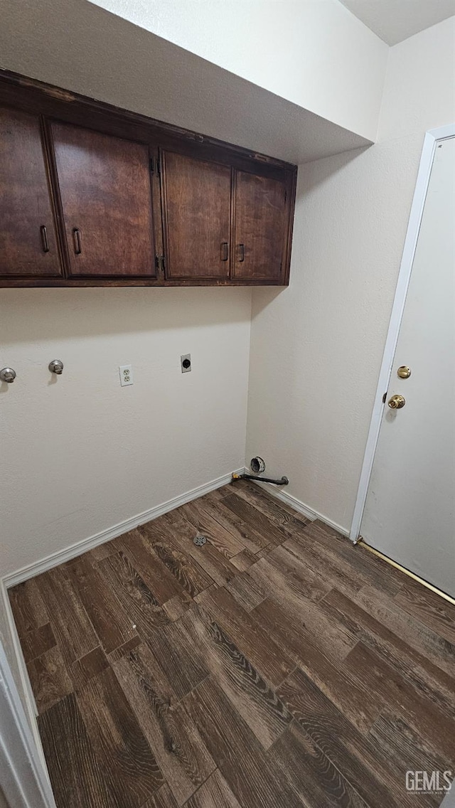 clothes washing area with cabinet space, baseboards, electric dryer hookup, and wood finished floors