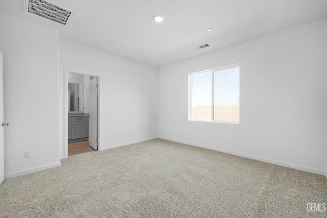 unfurnished bedroom with light carpet, baseboards, visible vents, and recessed lighting