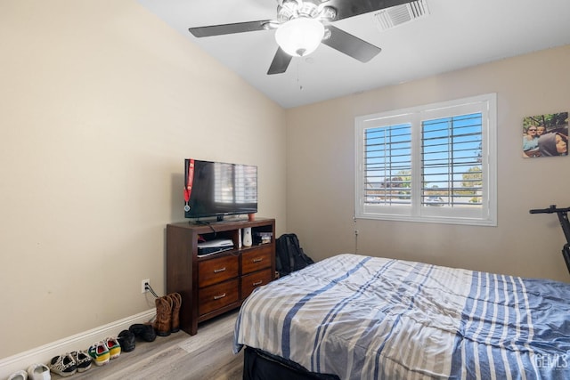 bedroom with baseboards, ceiling fan, wood finished floors, and visible vents