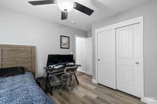 bedroom featuring ceiling fan, wood finished floors, and a closet