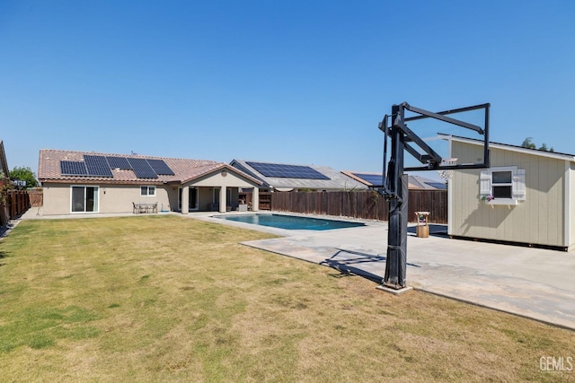 view of swimming pool featuring a fenced backyard, a fenced in pool, a yard, and a patio area