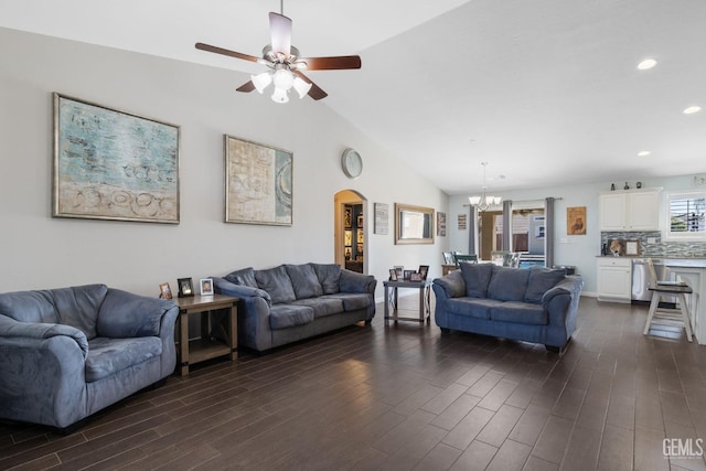 living area with lofted ceiling, recessed lighting, arched walkways, dark wood finished floors, and ceiling fan with notable chandelier