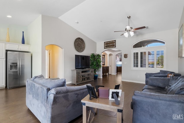 living room featuring dark wood-type flooring, arched walkways, ceiling fan, and high vaulted ceiling