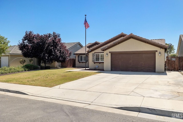 ranch-style house featuring a garage, a front lawn, fence, stucco siding, and concrete driveway